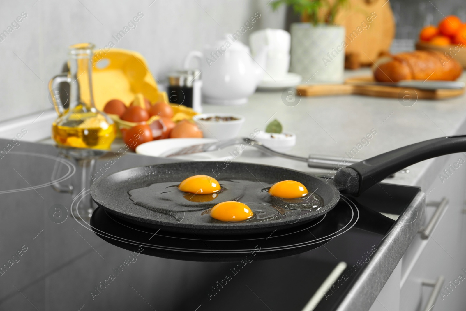 Photo of Cooking tasty eggs on frying pan in kitchen, closeup