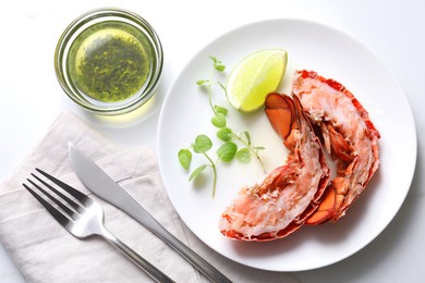 Photo of Delicious boiled lobster served on white table, flat lay