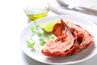 Photo of Delicious boiled lobster served on white table, closeup