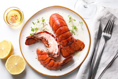 Photo of Delicious tails of boiled lobsters served on white table, flat lay