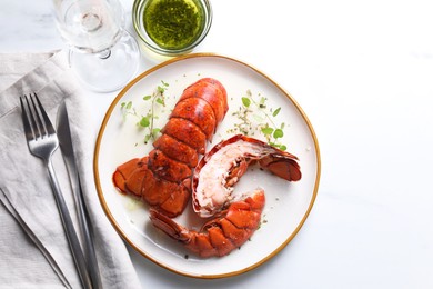 Photo of Delicious tails of boiled lobsters served on white table, flat lay