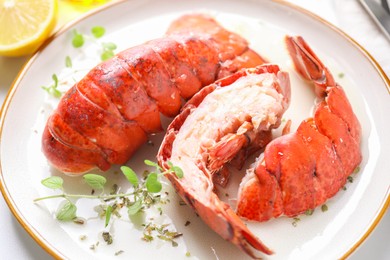 Photo of Delicious tails of boiled lobsters served on white table, closeup