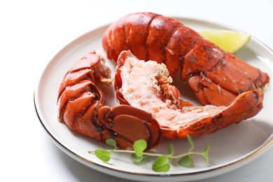 Photo of Delicious tails of boiled lobsters served on white table, closeup