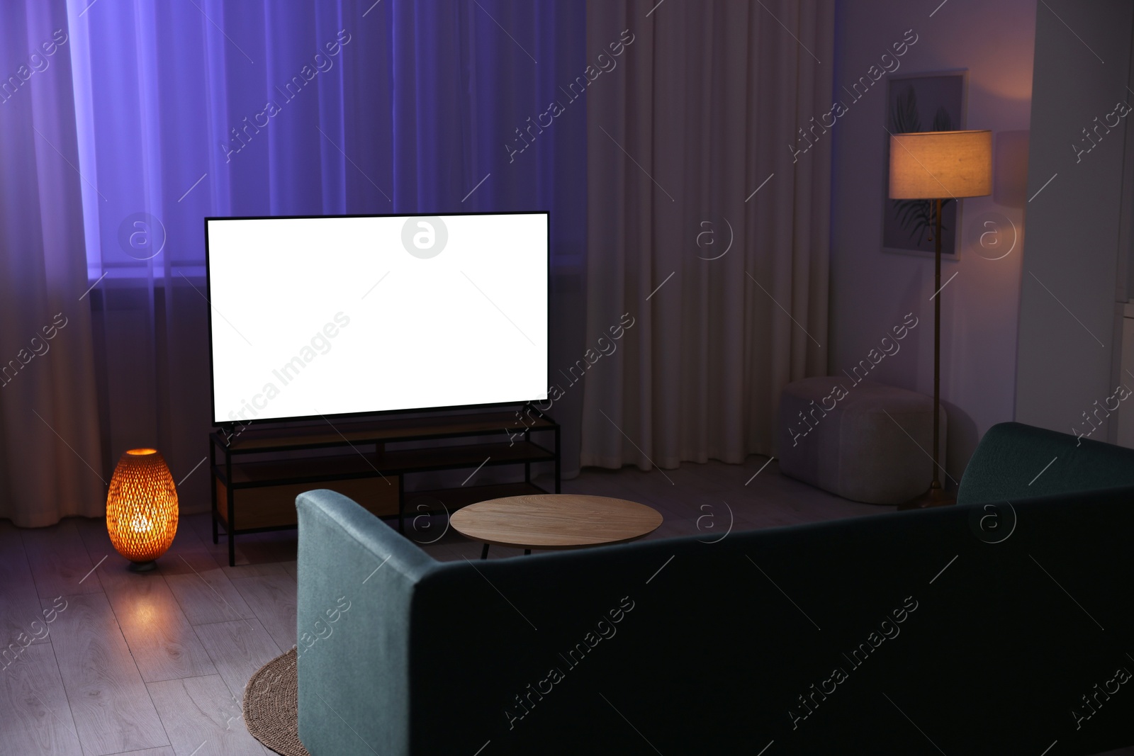 Photo of Big modern tv in stylish living room at evening