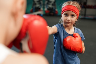 Children having boxing practice in training center