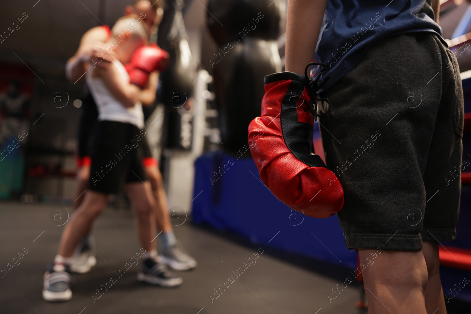 Photo of Girl at boxing practice in training center, closeup