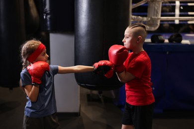 Photo of Children having boxing practice in training center