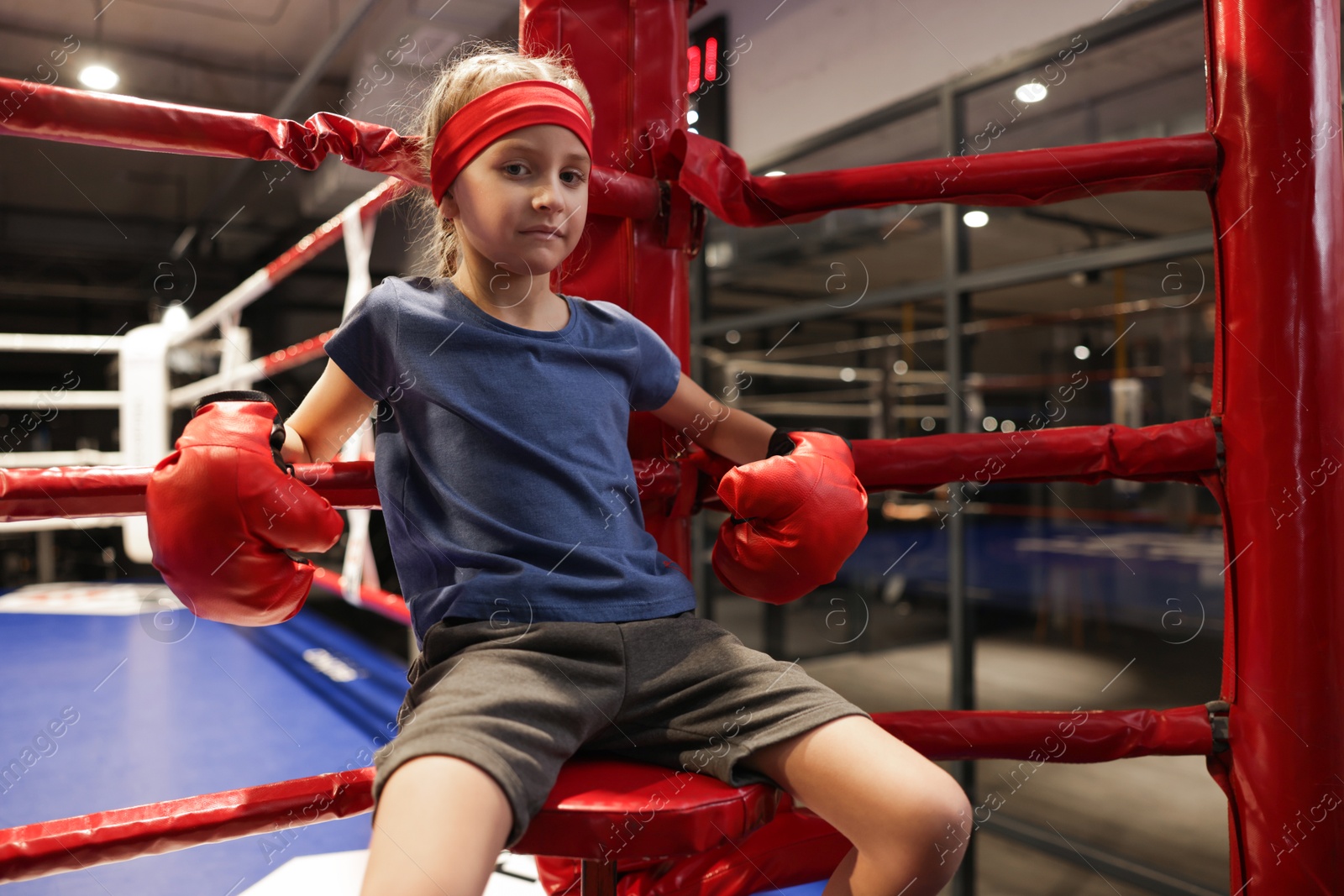 Photo of Girl sitting in her corner of boxing ring