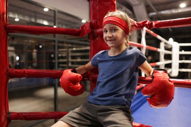 Girl sitting in her corner of boxing ring