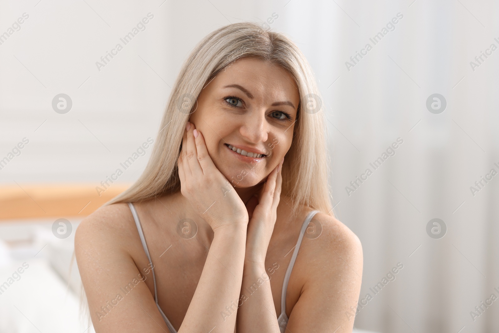 Photo of Portrait of beautiful woman with blonde hair indoors