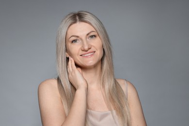 Photo of Portrait of beautiful woman on grey background