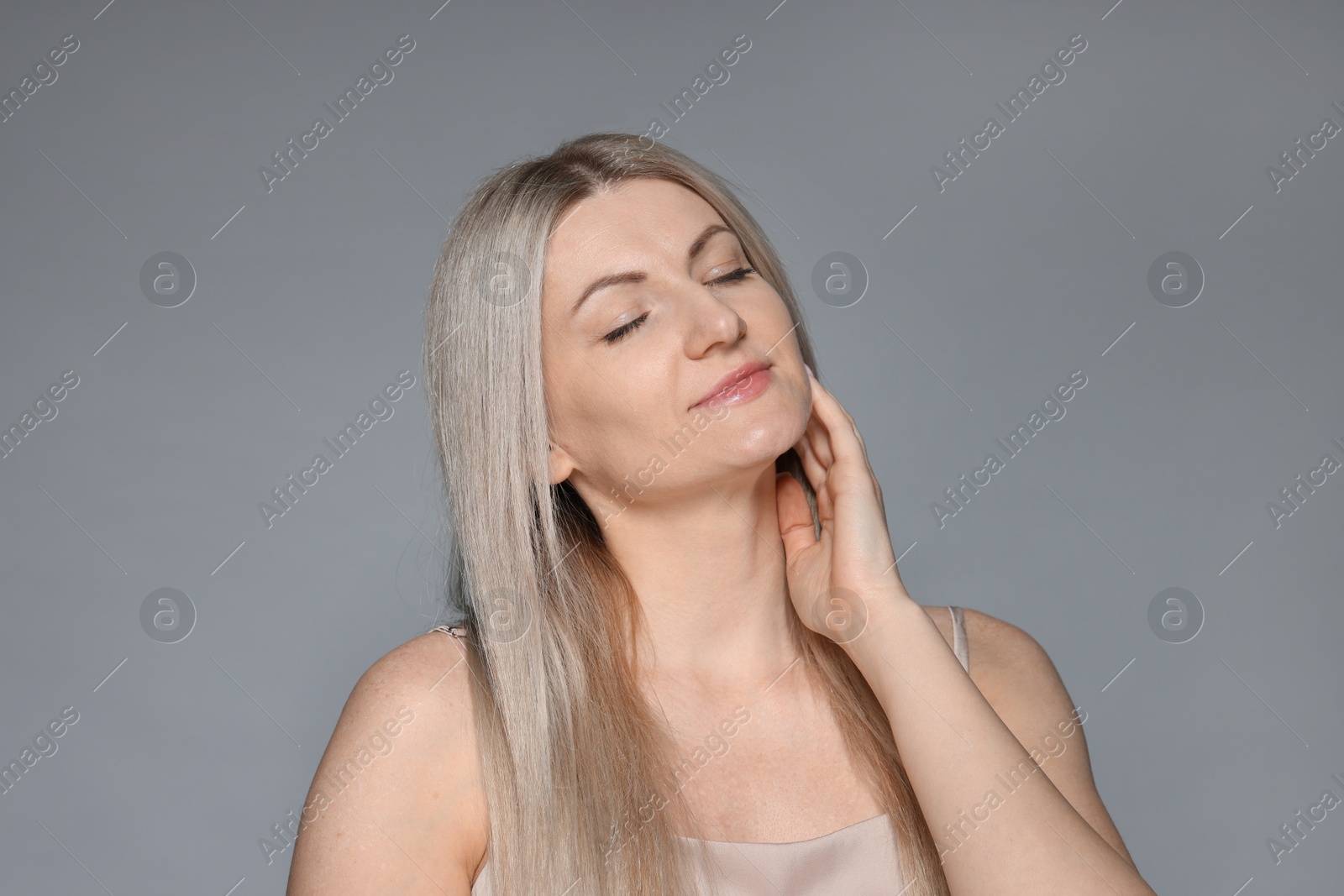 Photo of Portrait of beautiful woman on grey background