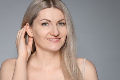 Photo of Portrait of beautiful woman on grey background