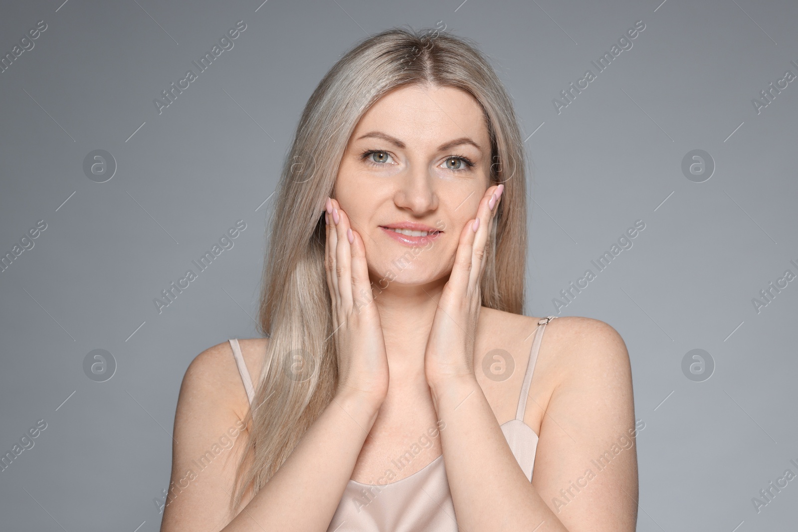 Photo of Portrait of beautiful woman on grey background