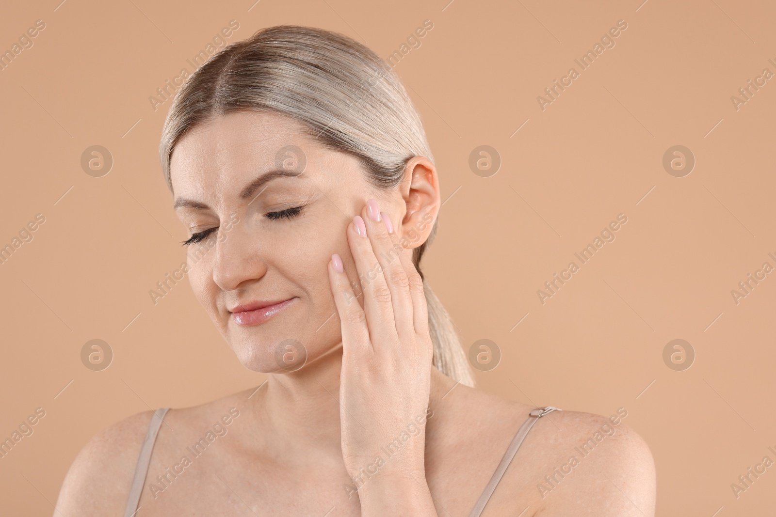 Photo of Portrait of beautiful woman on beige background. Space for text