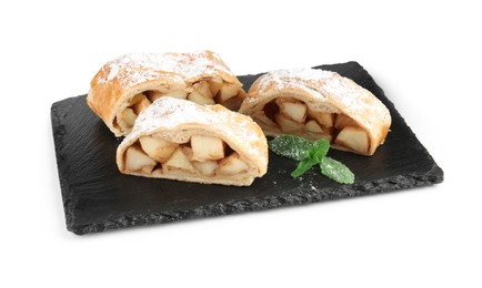 Photo of Pieces of tasty apple strudel with powdered sugar and mint isolated on white