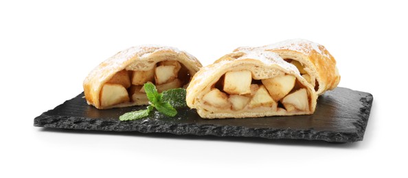 Photo of Pieces of tasty apple strudel with powdered sugar and mint isolated on white