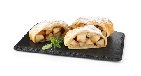 Photo of Pieces of tasty apple strudel with powdered sugar and mint isolated on white