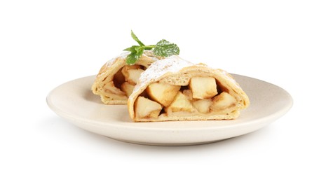 Photo of Pieces of tasty apple strudel with powdered sugar and mint isolated on white