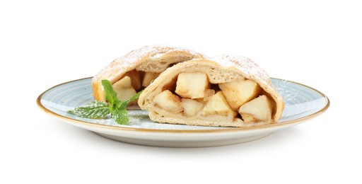 Photo of Pieces of tasty apple strudel with powdered sugar and mint isolated on white