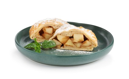 Photo of Pieces of tasty apple strudel with powdered sugar and mint isolated on white