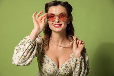 Photo of Happy woman on green background. Pin-up vibe portrait