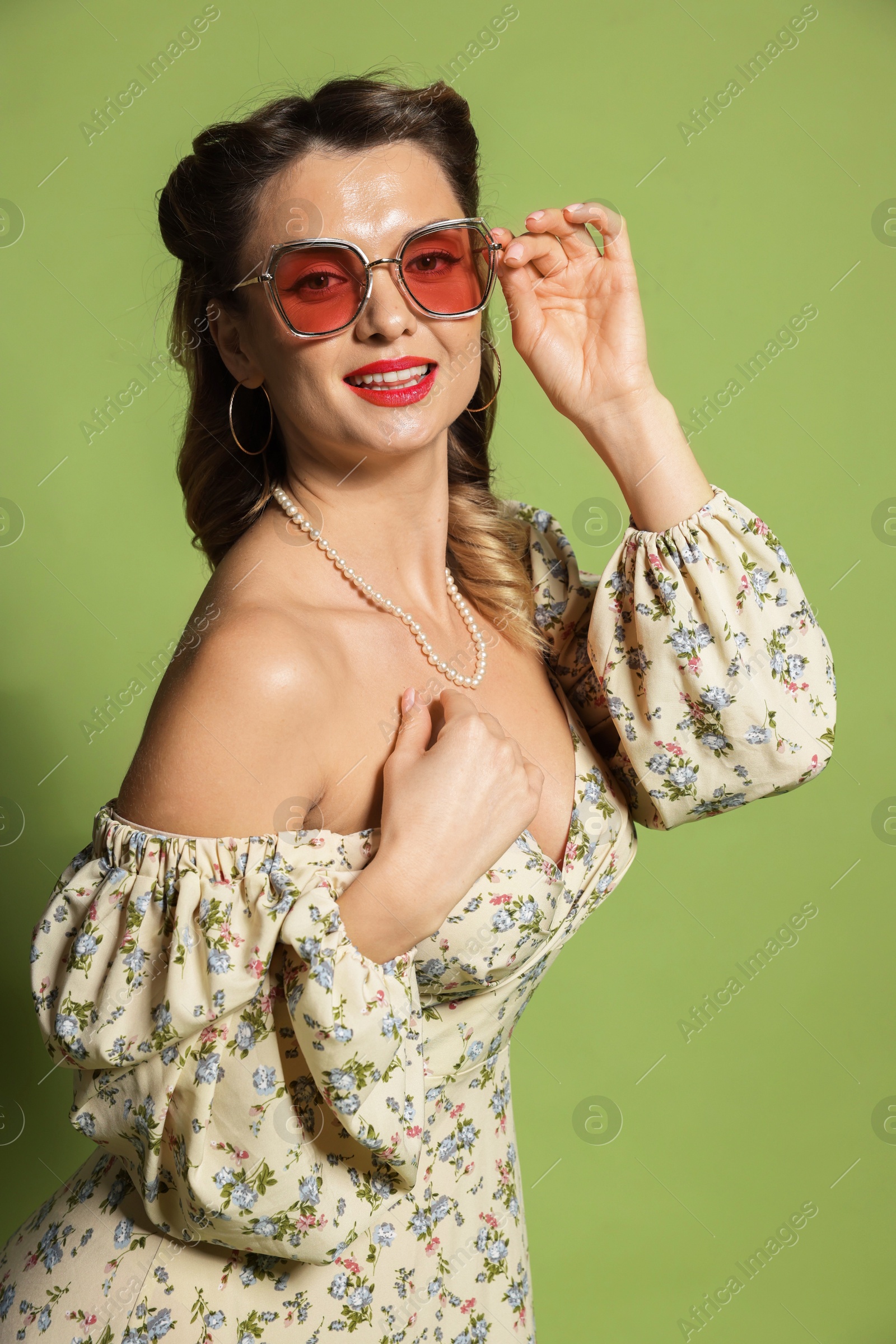 Photo of Happy woman on green background. Pin-up vibe portrait