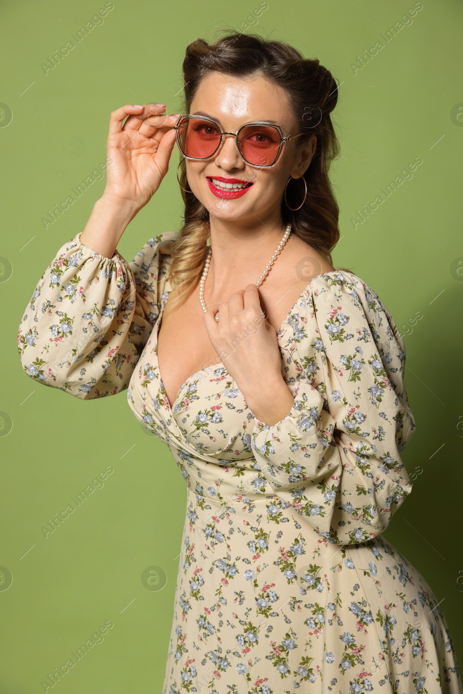 Photo of Happy woman on green background. Pin-up vibe portrait