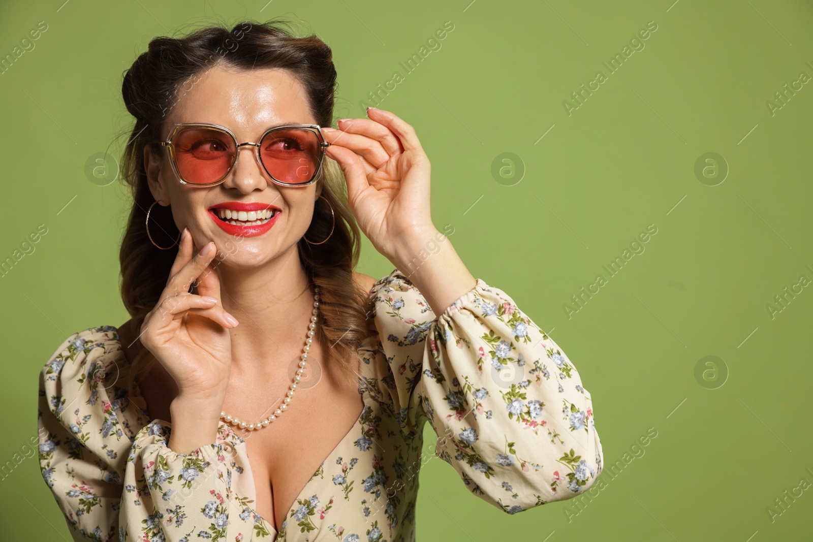 Photo of Happy woman on green background, space for text. Pin-up vibe portrait