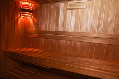 Photo of View of empty wooden sauna with bench