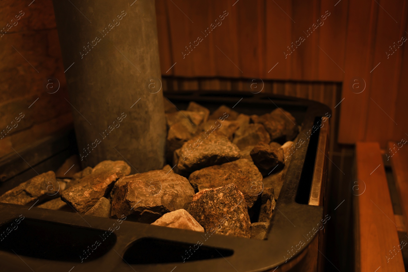 Photo of Stove with hot rocks in sauna, closeup