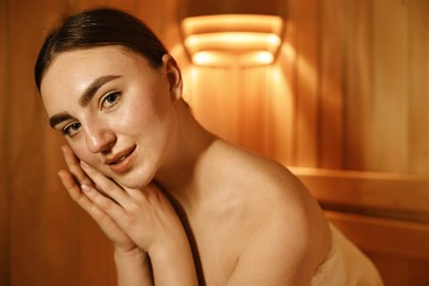 Photo of Beautiful young woman relaxing in hot sauna