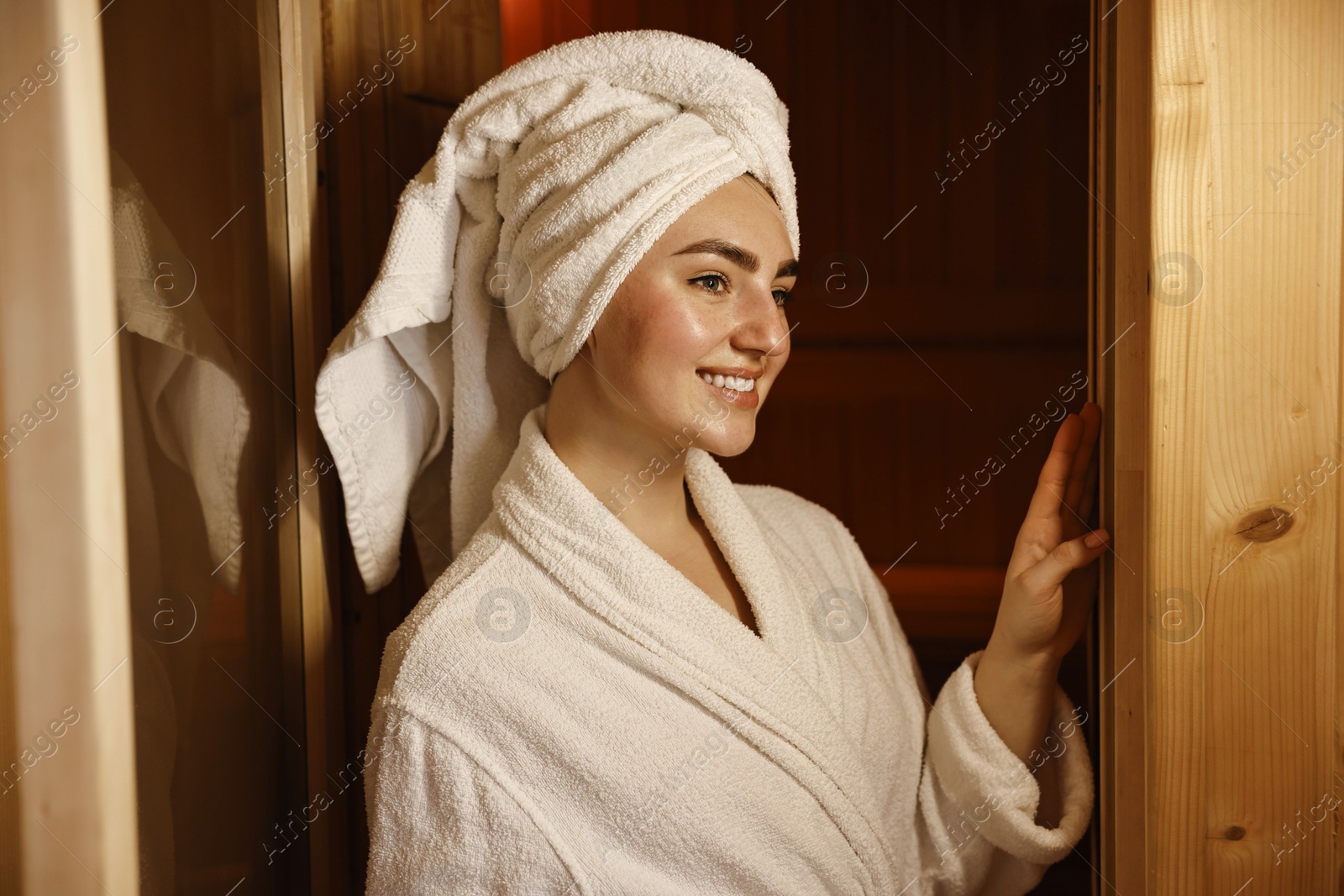 Photo of Beautiful woman in bathrobe relaxing at sauna