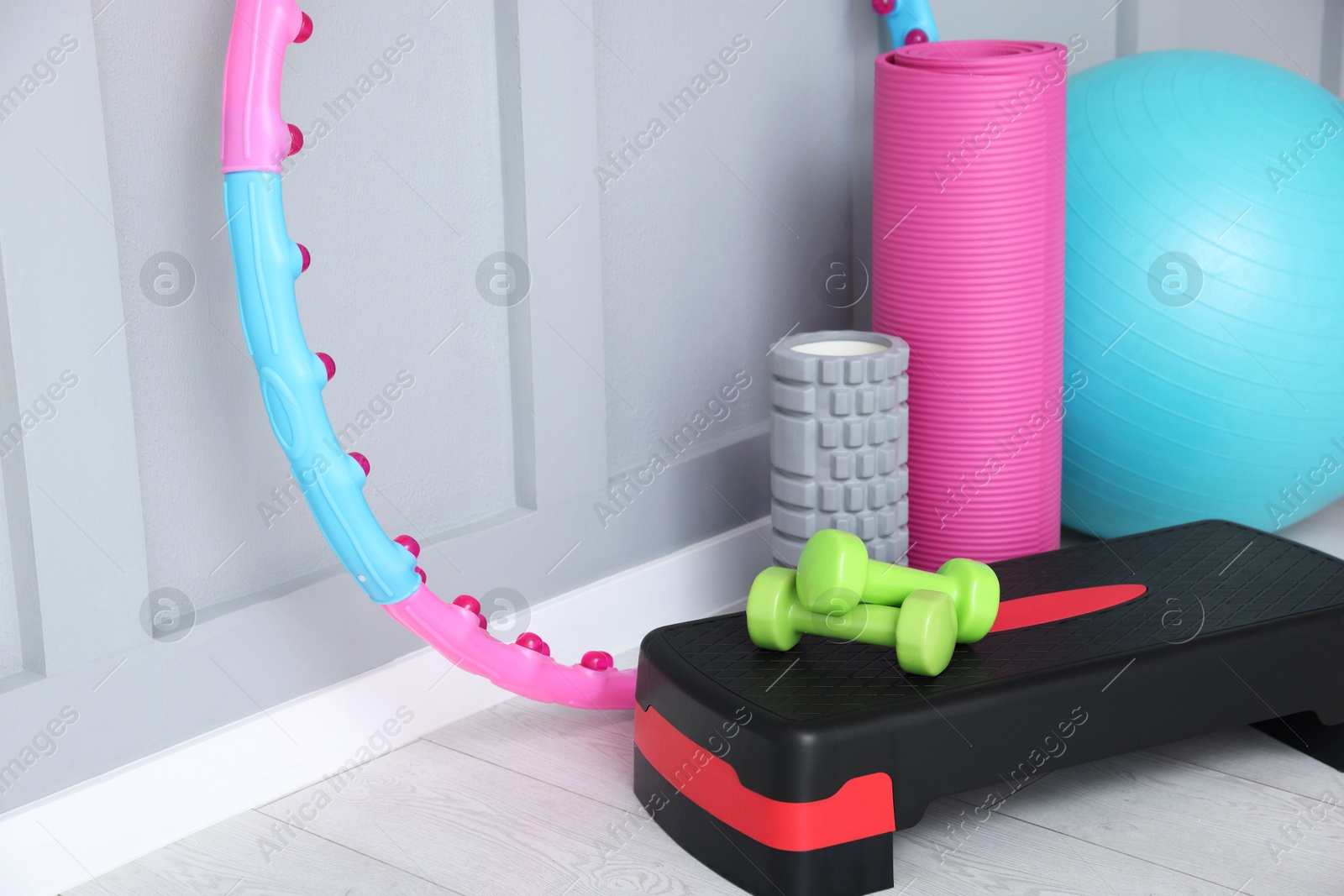 Photo of Different fitness equipment near grey wall indoors