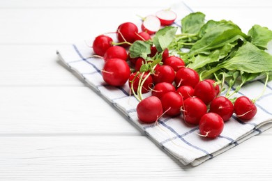 Photo of Many fresh radishes on white wooden table, closeup. Space for text