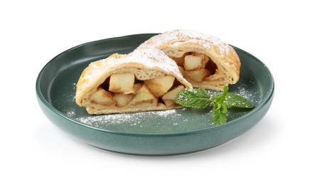 Photo of Pieces of tasty apple strudel with powdered sugar and mint isolated on white