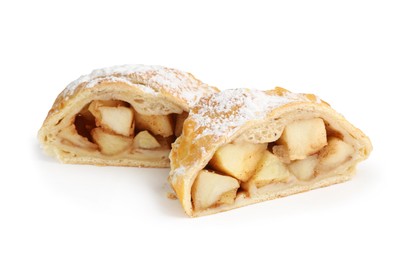 Photo of Pieces of tasty apple strudel with powdered sugar isolated on white