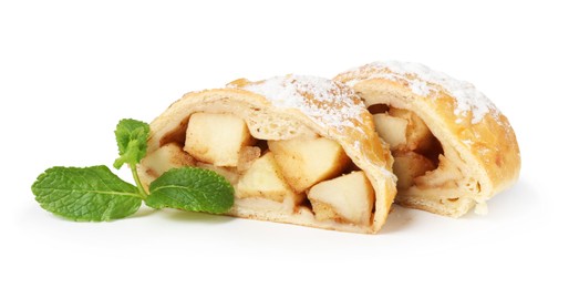 Photo of Pieces of tasty apple strudel with powdered sugar and mint isolated on white