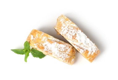 Photo of Pieces of tasty apple strudel with powdered sugar and mint isolated on white, top view