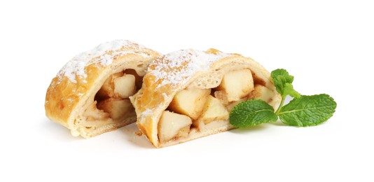 Photo of Pieces of tasty apple strudel with powdered sugar and mint isolated on white