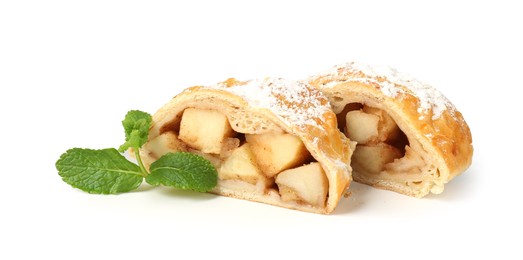 Photo of Pieces of tasty apple strudel with powdered sugar and mint isolated on white