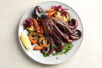 Roasted octopus with vegetables and mushrooms on light grey table, top view