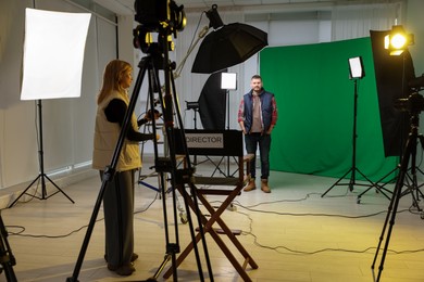 People working with professional equipment in film studio