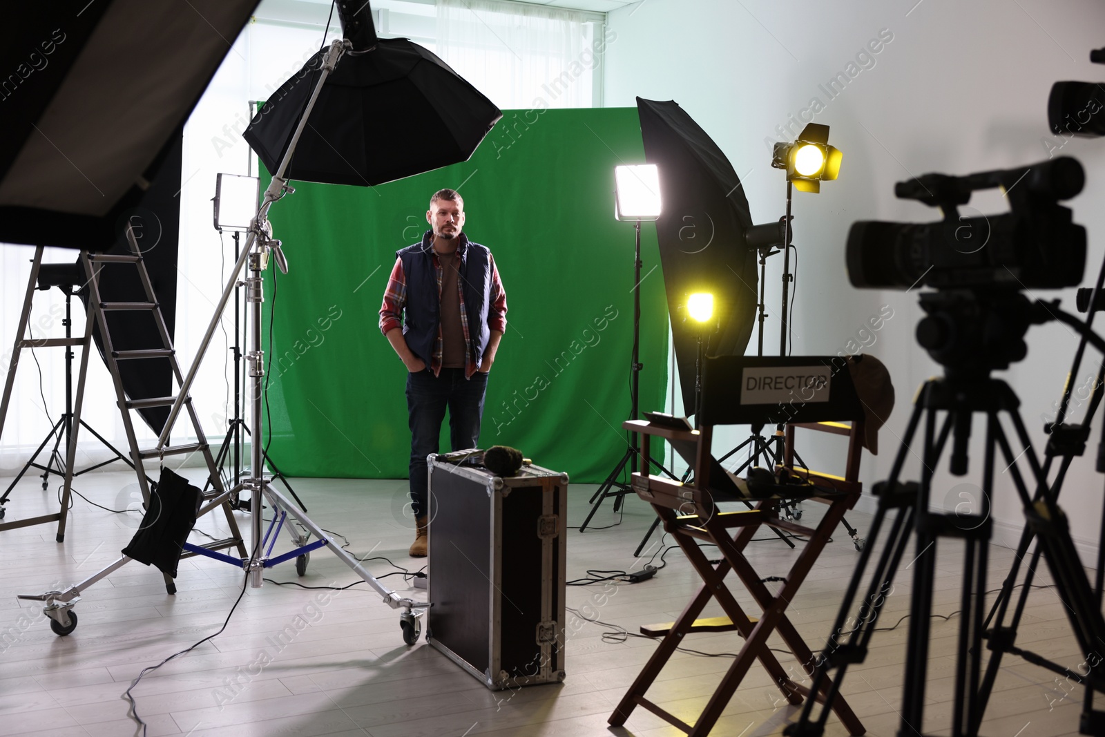 Photo of Man working in modern film studio with professional equipment