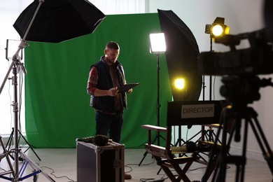 Man working in modern film studio with professional equipment