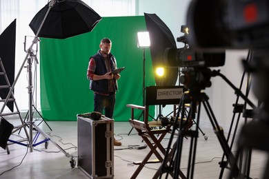 Man working in modern film studio with professional equipment