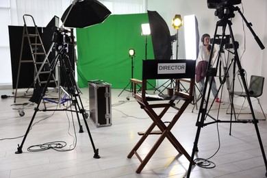 Photo of Woman working in modern film studio with professional equipment