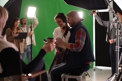 Photo of Group of people working in modern film studio