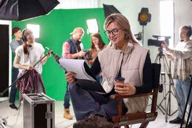 Group of people working in modern film studio