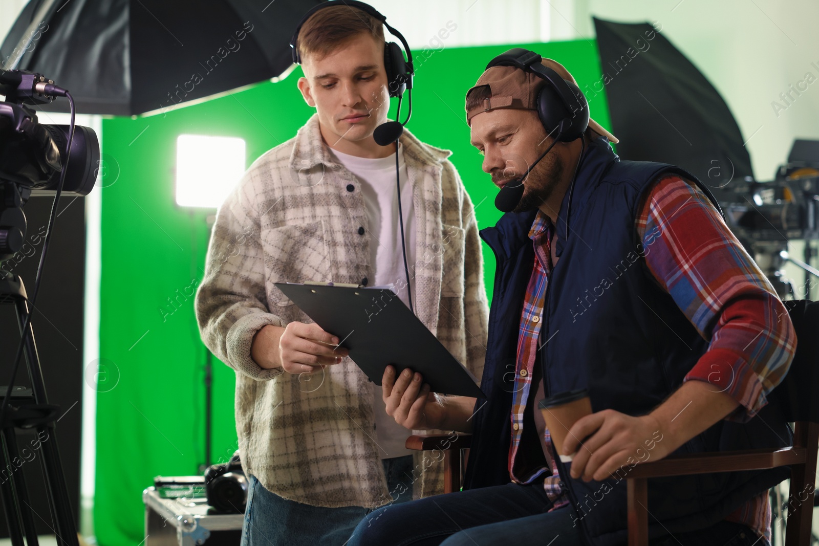 Photo of Men working with professional equipment in modern film studio